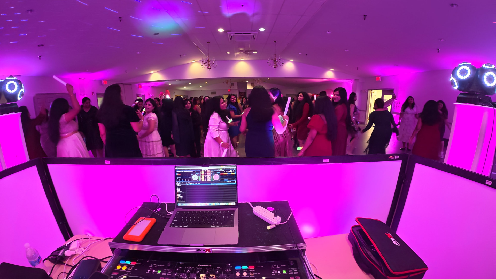DJ Diamond Fusion booth lighting a packed dance floor in magenta light